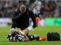 Newcastle United's Joelinton receives medical attention after sustaining an injury on December 16, 2023