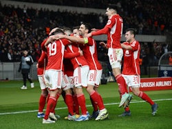 FC Union Berlin players celebrate after Kevin Volland scores their first goal on December 12, 2023