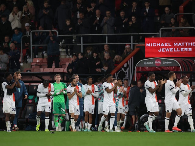 Luton Town players applaud fans after the match is suspended on December 16, 2023