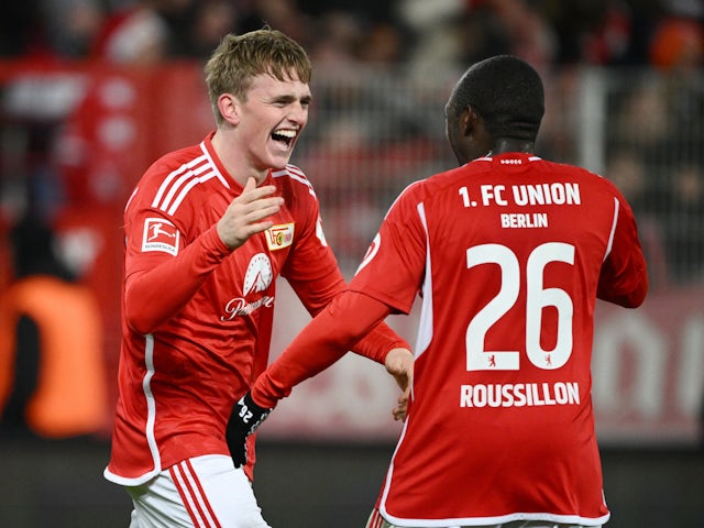 Union Berlin's Mikkel Kaufmann celebrates scoring their third goal with Jerome Roussillon on December 9, 2023