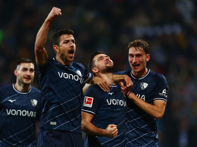 VfL Bochum's Kevin Stoger celebrates scoring their third goal with Anthony Losilla and Patrick Osterhage on December 16, 2023