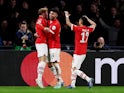 PSV Eindhoven's Yorbe Vertessen celebrates scoring their first goal with teammates on December 12, 2023