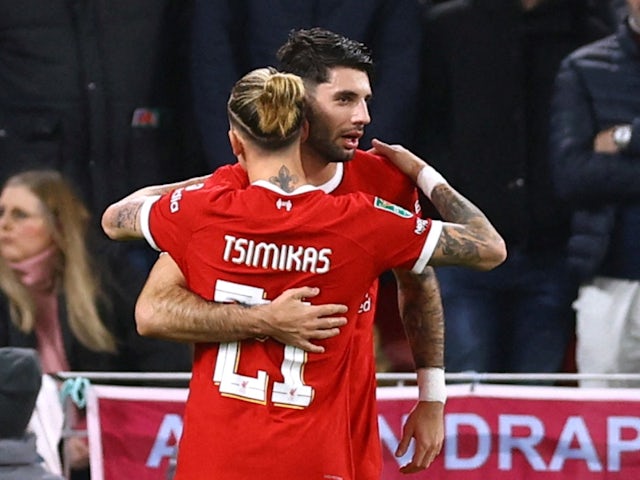 Liverpool's Dominik Szoboszlai celebrates scoring their first goal with teammate Kostas Tsimikas on December 20, 2023