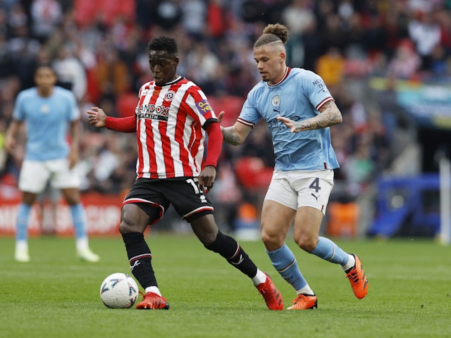 Sheffield United's Ismaila Coulibaly in action with Manchester City's Kalvin Phillips  on April 22, 2023