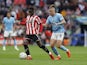 Sheffield United's Ismaila Coulibaly in action with Manchester City's Kalvin Phillips  on April 22, 2023
