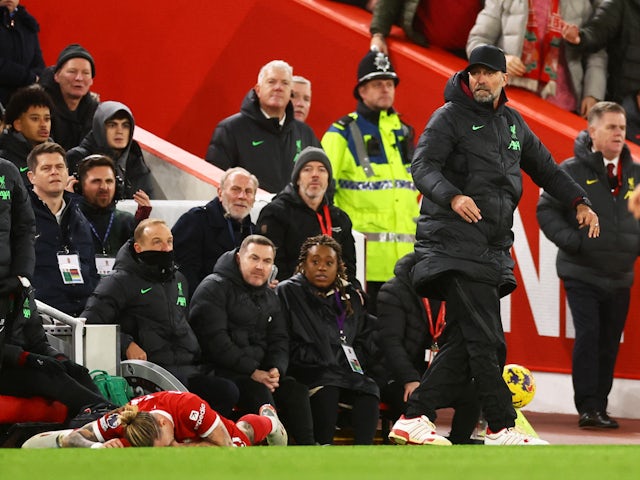 Liverpool's Kostas Tsimikas lies on the ground after sustaining an injury on December 23, 2023