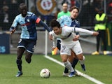 Paris Saint-Germain's Lee Kang-in in action with Le Havre's Arouna Sangante and Daler Kuzyayev on December 3, 2023