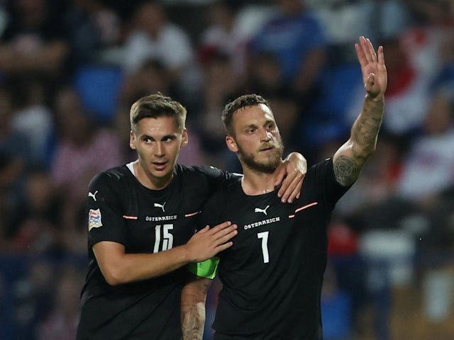 Austria's Marko Arnautovic celebrates with Maximilian Wober after scoring their first goal on June 3, 2022