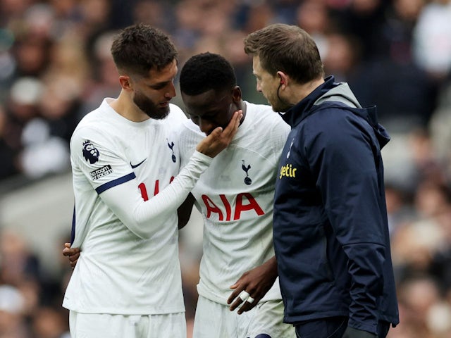 Tottenham Hotspur's Pape Matar Sarr with Rodrigo Bentancur after sustaining an injury on December 31, 2023