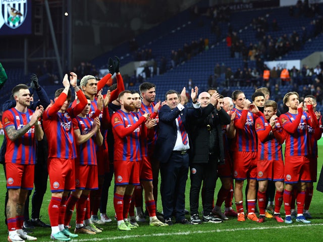 Aldershot manager Tommy Widdrington and players applaud fans after the match on January 7, 2024
