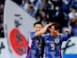 Japan's Takumu Kawamura celebrates with Yukinari Sugiyama after scoring a goal on January 1, 2024