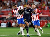 Real Madrid's Joselu in action with Girona's Aleix Garcia and Daley Blind on September 30, 2023