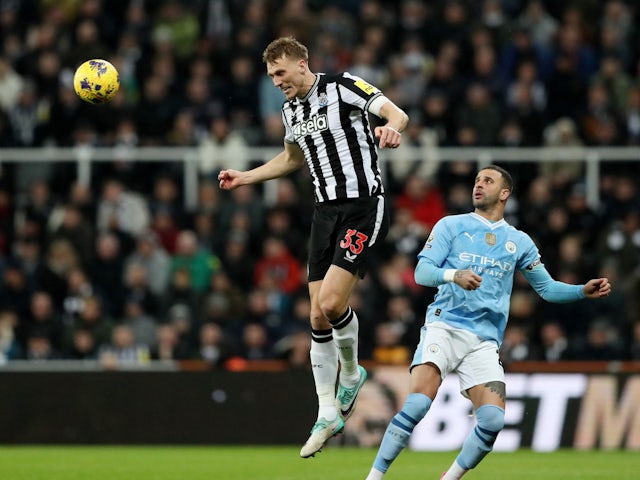 Newcastle United's Dan Burn in action with Manchester City's Kyle Walker on January 13, 2024