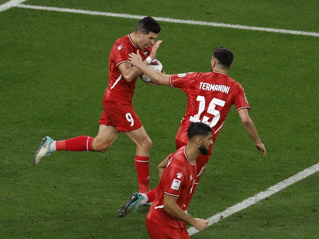 Palestine's Tamer Seyam celebrates scoring their first goal with Michael Termanini on January 14, 2024