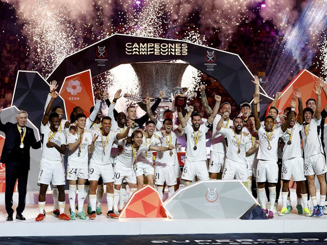 Real Madrid's Nacho lifts the trophy with teammates and coach Carlo Ancelotti after winning the Spanish Super Cup on January 14, 2024