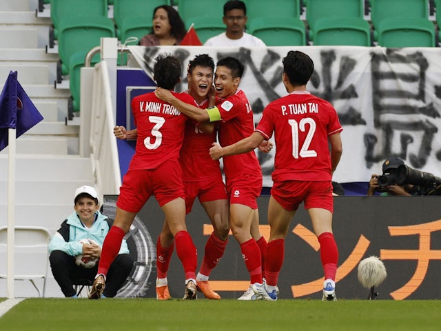 Vietnam's Pham Tuan Hai celebrates scoring their second goal with Vo Minh Trong, Do Hung Dung and Phan Tuan Tai on January 14, 2024
