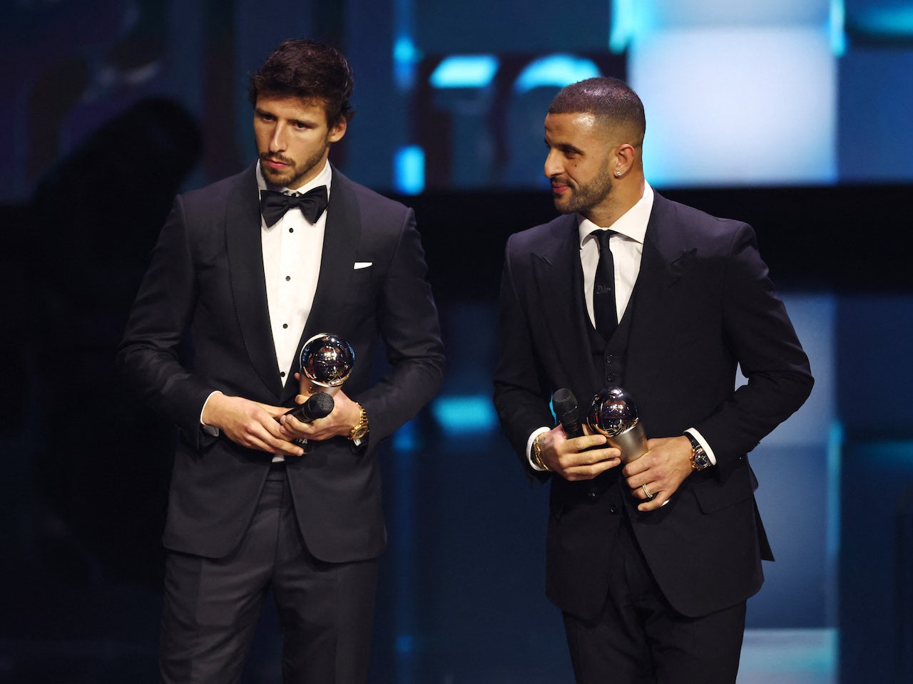 Manchester City's Ruben Dias and Kyle Walker are pictured on stage ...