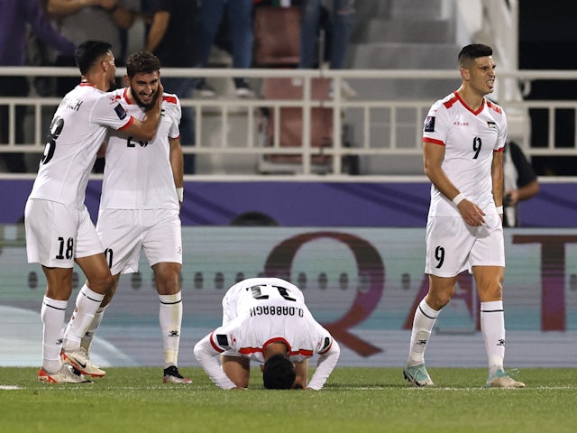 Oday Dabbagh celebrates his goal at the Asian Cup with his Palestine teammates