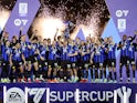 Inter Milan's Lautaro Martinez lifts the trophy with teammates after winning the Supercoppa Italiana on January 22, 2024
