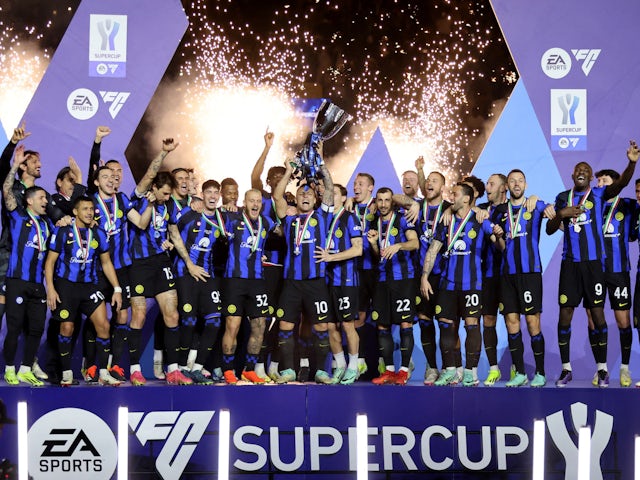 Inter Milan's Lautaro Martinez lifts the trophy with teammates after winning the Supercoppa Italiana on January 22, 2024