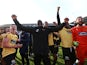 Maidstone United manager George Elokobi and players celebrate after the match on January 27, 2024