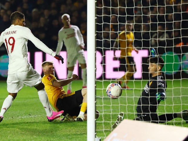 Newport County's Will Evans scores against Manchester United on January 28, 2024