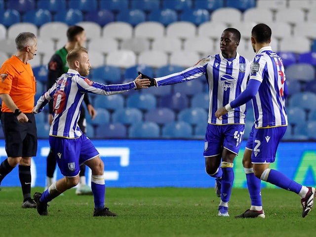 Sheffield Wednesday's Djeidi Gassama celebrates scoring their first goal with teammates on January 27, 2024
