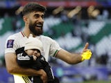 Ali Gholizadeh celebrates with his son as Iran defeated Japan at the 2023 Asian Cup