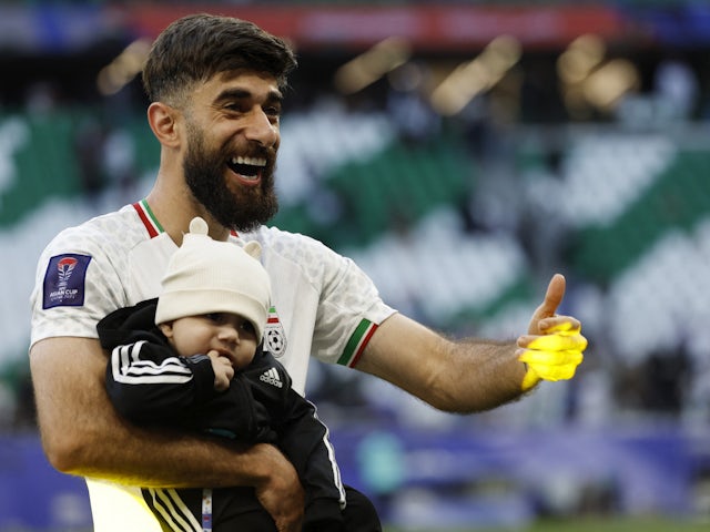 Ali Gholizadeh celebrates with his son as Iran defeated Japan at the 2023 Asian Cup