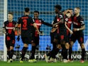 Bayer Leverkusen's Josip Stanisic celebrates scoring their first goal with teammates on February 10, 2024