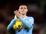 Manchester City's Phil Foden celebrates with the match ball after completing a hat-trick on February 5, 2024