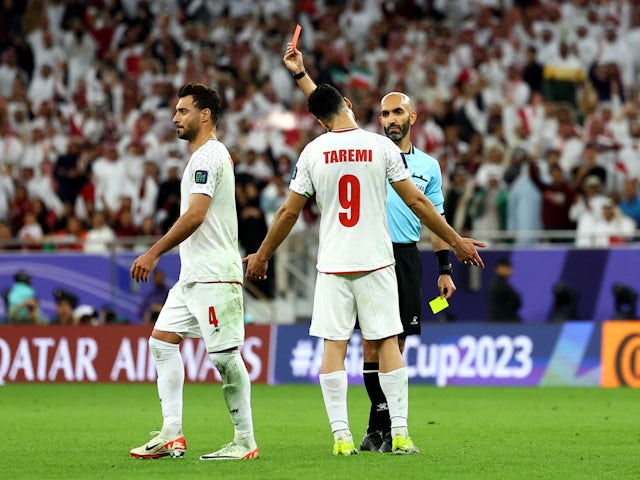 Iran's Shoja Khalilzadeh is shown a red card by referee Ahmad Al Ali on February 7, 2024