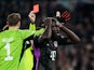 Bayern Munich's Dayot Upamecano is shown a red card on February 14, 2024