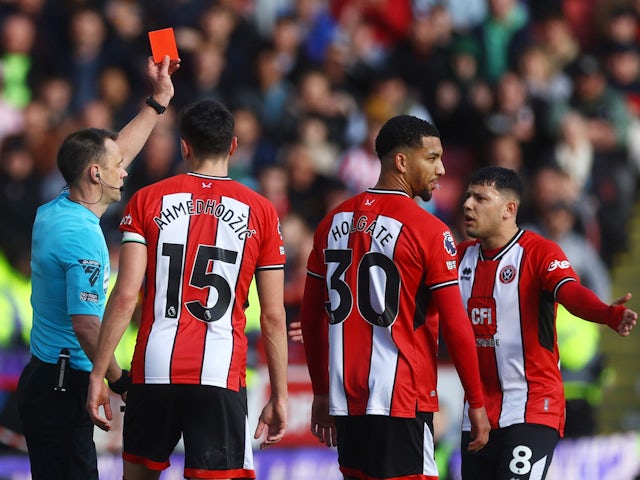 Sheffield United's Mason Holgate is shown a red card by referee Stuart Attwell on February 18, 2024