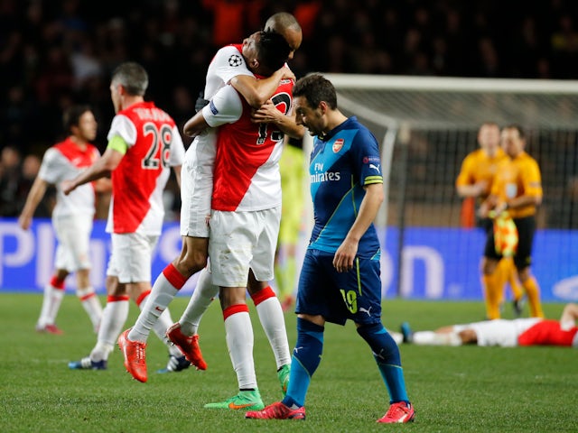AS Monaco's Wallace (C) celebrates with Fabinho as Arsenal's Santi Cazorla (R) walks past after their Champions League round of 16 second leg on March 17, 2015