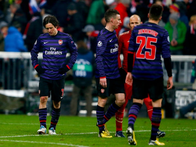 Arsenal's Tomas Rosicky (L) reacts following his team's Champions League round of 16 second leg on March 13, 2013