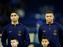Paris Saint-Germain's Achraf Hakimi and Kylian Mbappe line up before the match on February 14, 2024