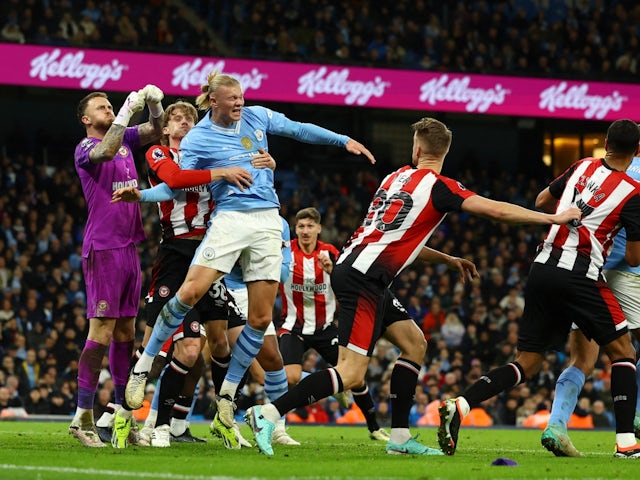 Brentford's Mark Flekken and Mads Roerslev in action with Manchester City's Erling Haaland on February 20, 2024