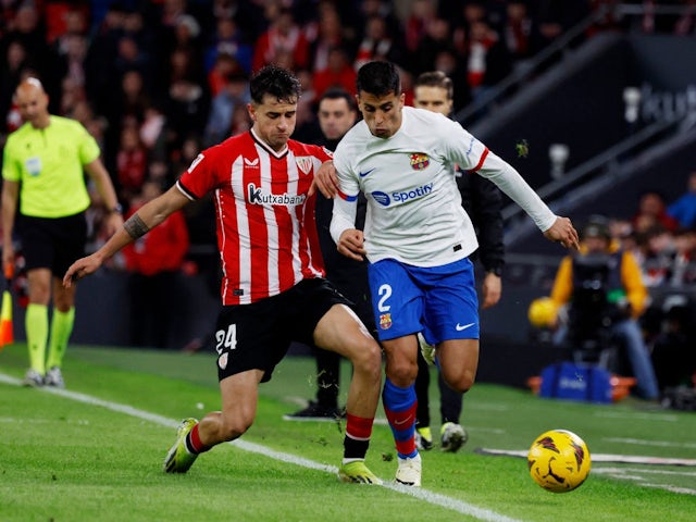 Athletic Bilbao's Benat Prados in action with FC Barcelona's Joao Cancelo on March 3, 2024