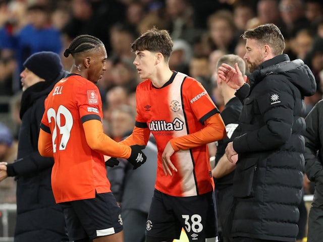 Luton Town's Joseph Johnson comes on as a substitute to replace Amari'i Bell as manager Rob Edwards looks on February 27, 2024