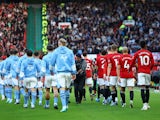 Manchester City and Manchester United players walk out before the match on October 29, 2023