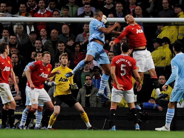 Manchester City's Vincent Kompany scores their first goal on April 30, 2012