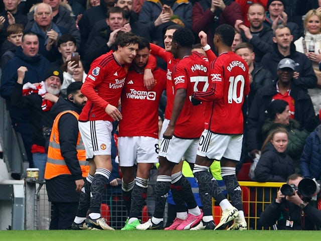 Manchester United's Bruno Fernandes celebrates scoring their first goal with teammates on March 9, 2024