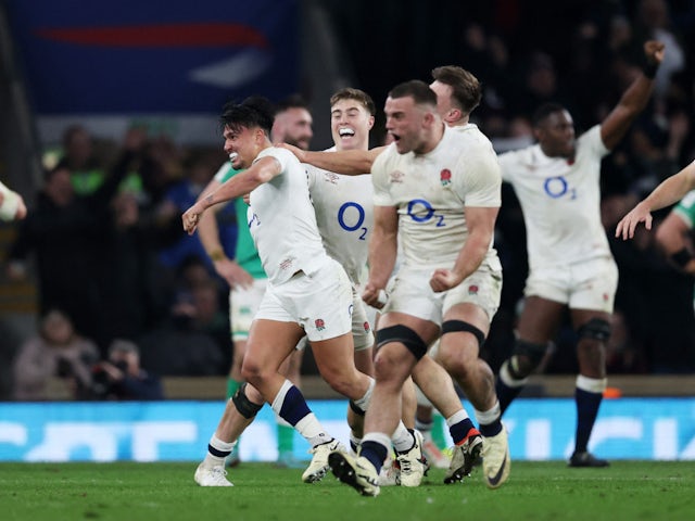 England's Marcus Smith celebrates with teammates after scoring a drop goal on March 9, 2024
