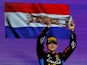 Red Bull's Max Verstappen celebrates with a trophy on the podium after winning the Saudi Arabian Grand Prix on March 9, 2024