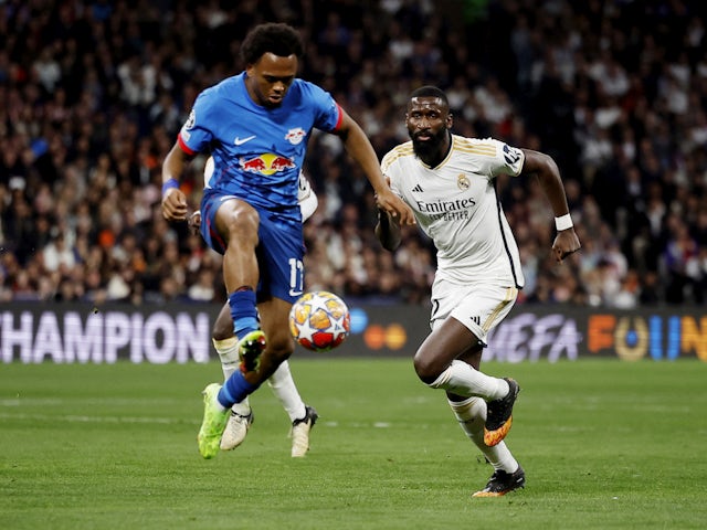 Antonio Rudiger of Real Madrid in action with Lois Openda of RB Leipzig on March 6, 2024