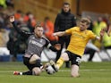 Fulham's Harrison Reed in action with Wolverhampton Wanderers' Tommy Doyle on March 9, 2024