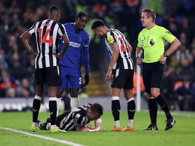 Newcastle United's Dan Burn reacts after sustaining an injury on March 11, 2024