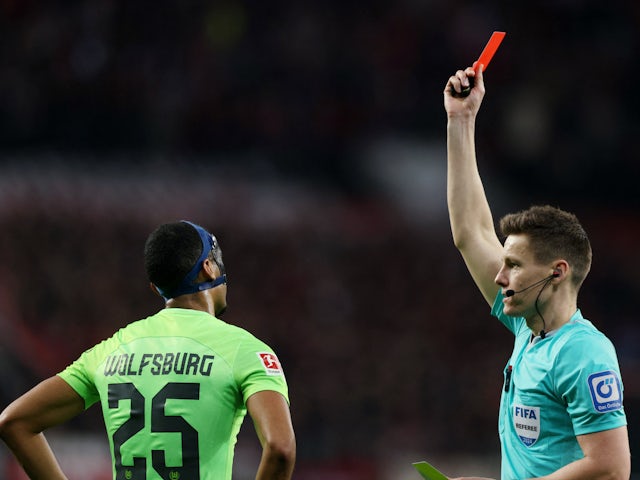 Wolfsburg's Moritz Jenz is shown a red card by referee Daniel Siebert on March 10, 2024