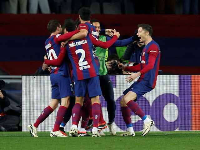 Barcelona's Robert Lewandowski celebrates scoring their third goal with teammates on March 12, 2024